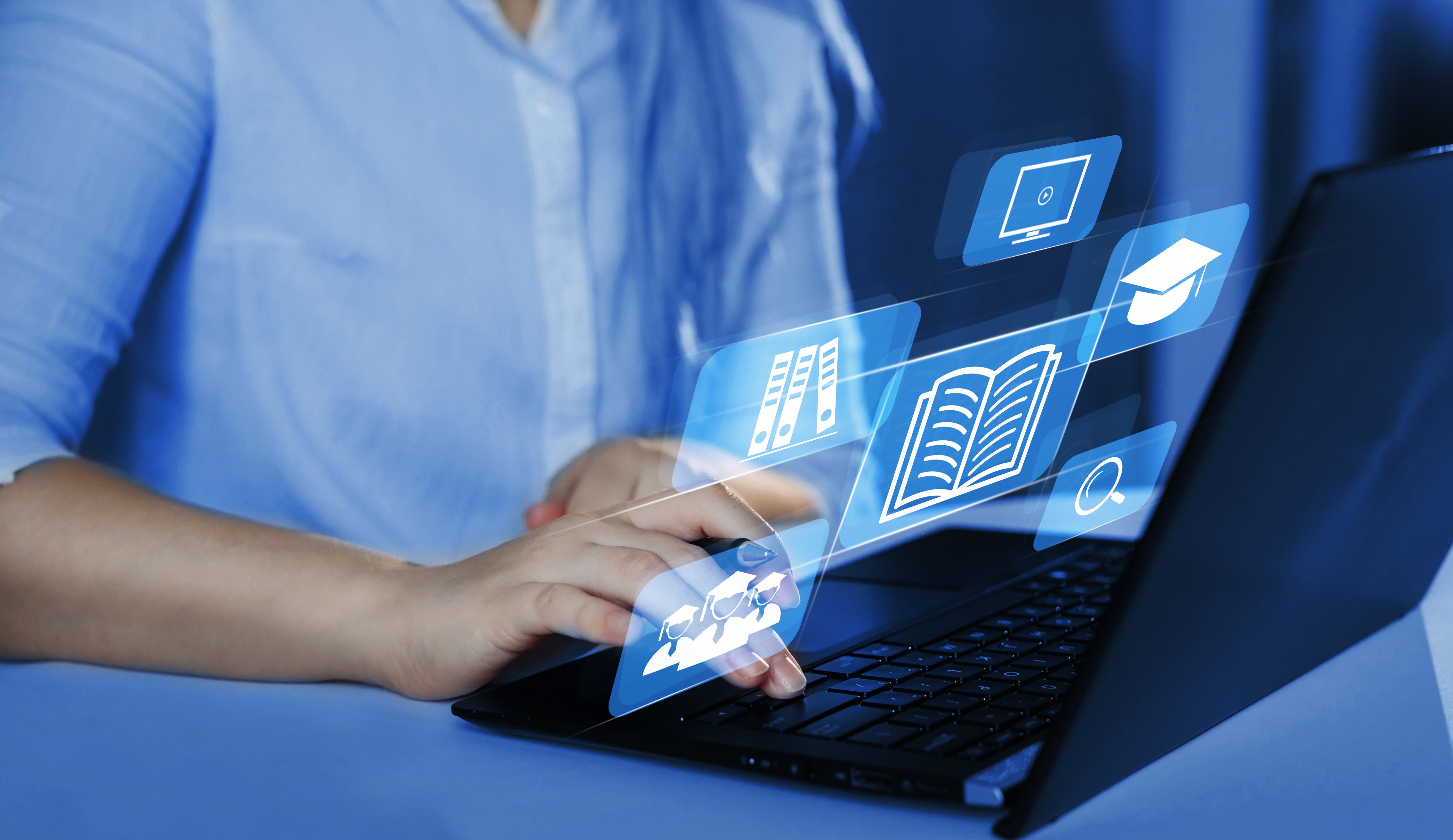 Person using a laptop with online learning icons