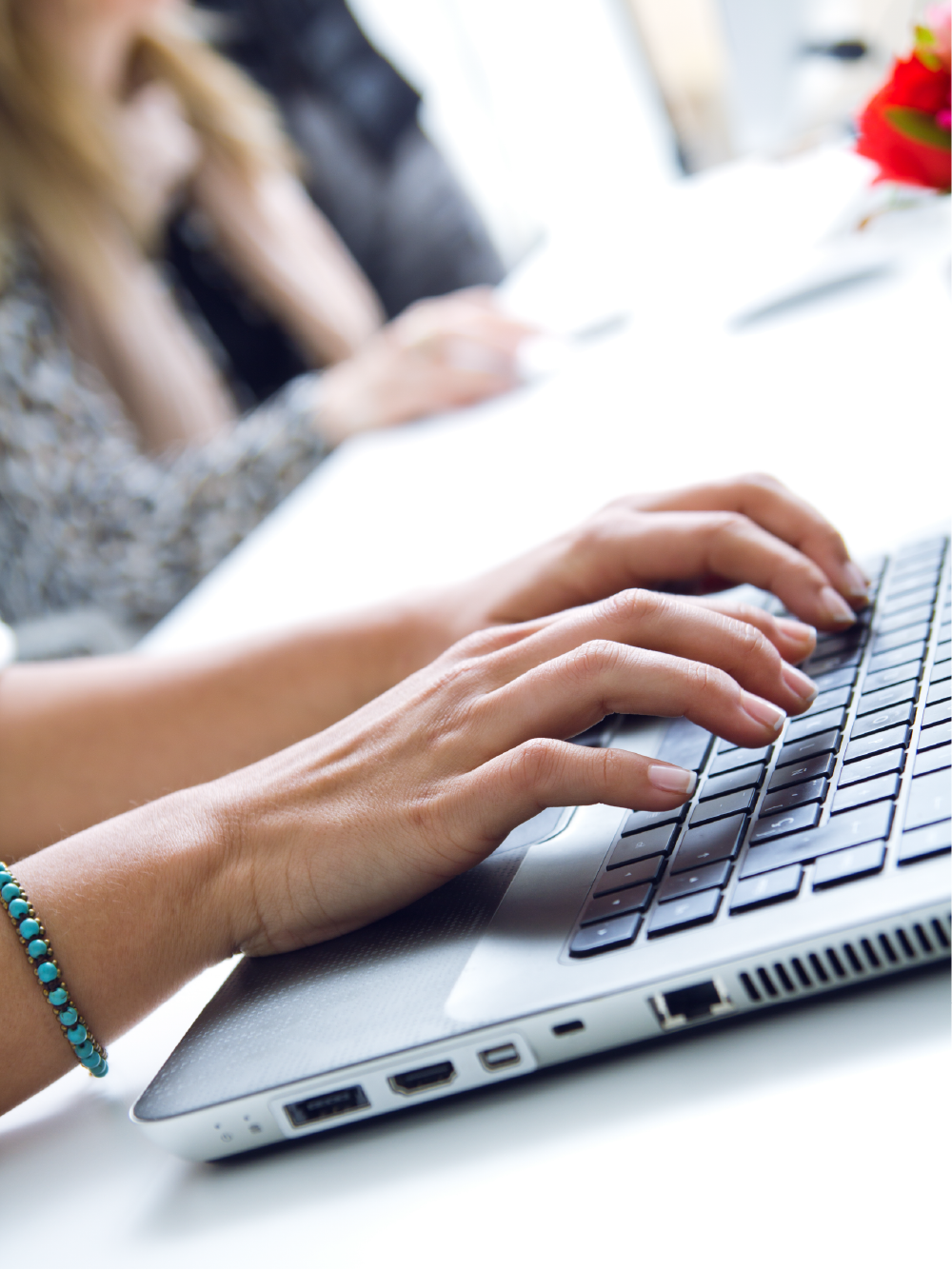 Close up of hands typing on a computer keyboard