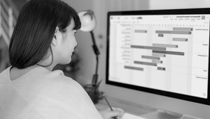 AlamoONLINE student facing computer while studying