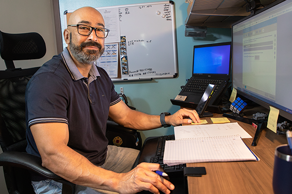 Roger a male student on his laptop in his home