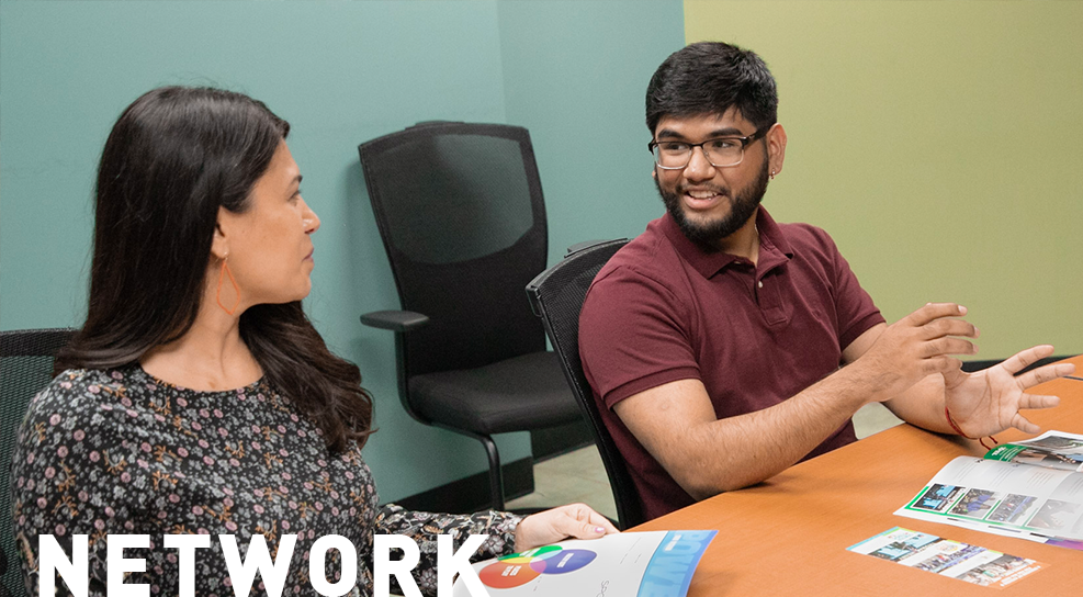 Two Alamo on the Job students sitting at a table talking