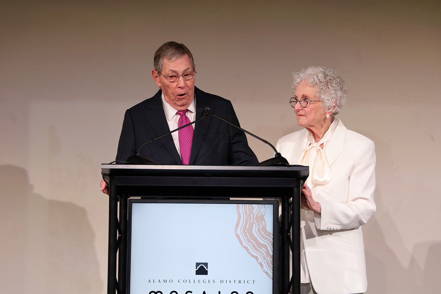 couple speaking at podium