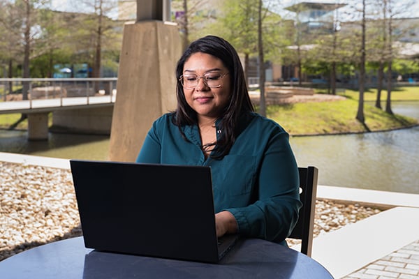 Mia_Sarah on her laptop image outside.jpg