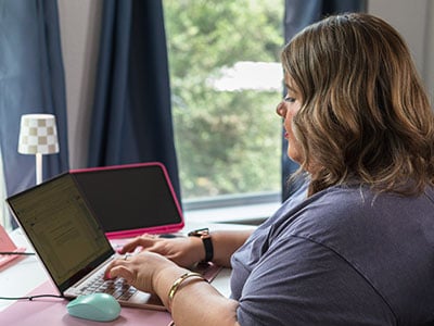 Kristen working on some homework on her laptop