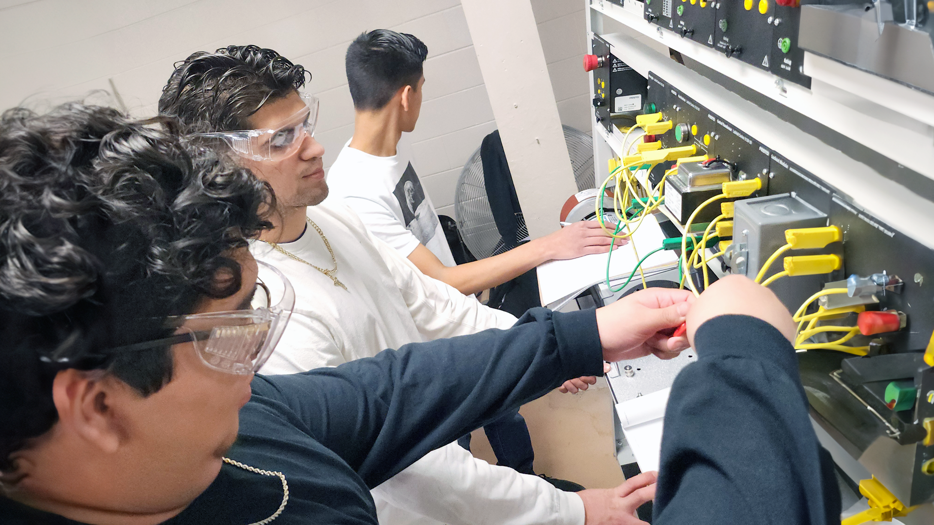 male students working in manufacturing maintenance