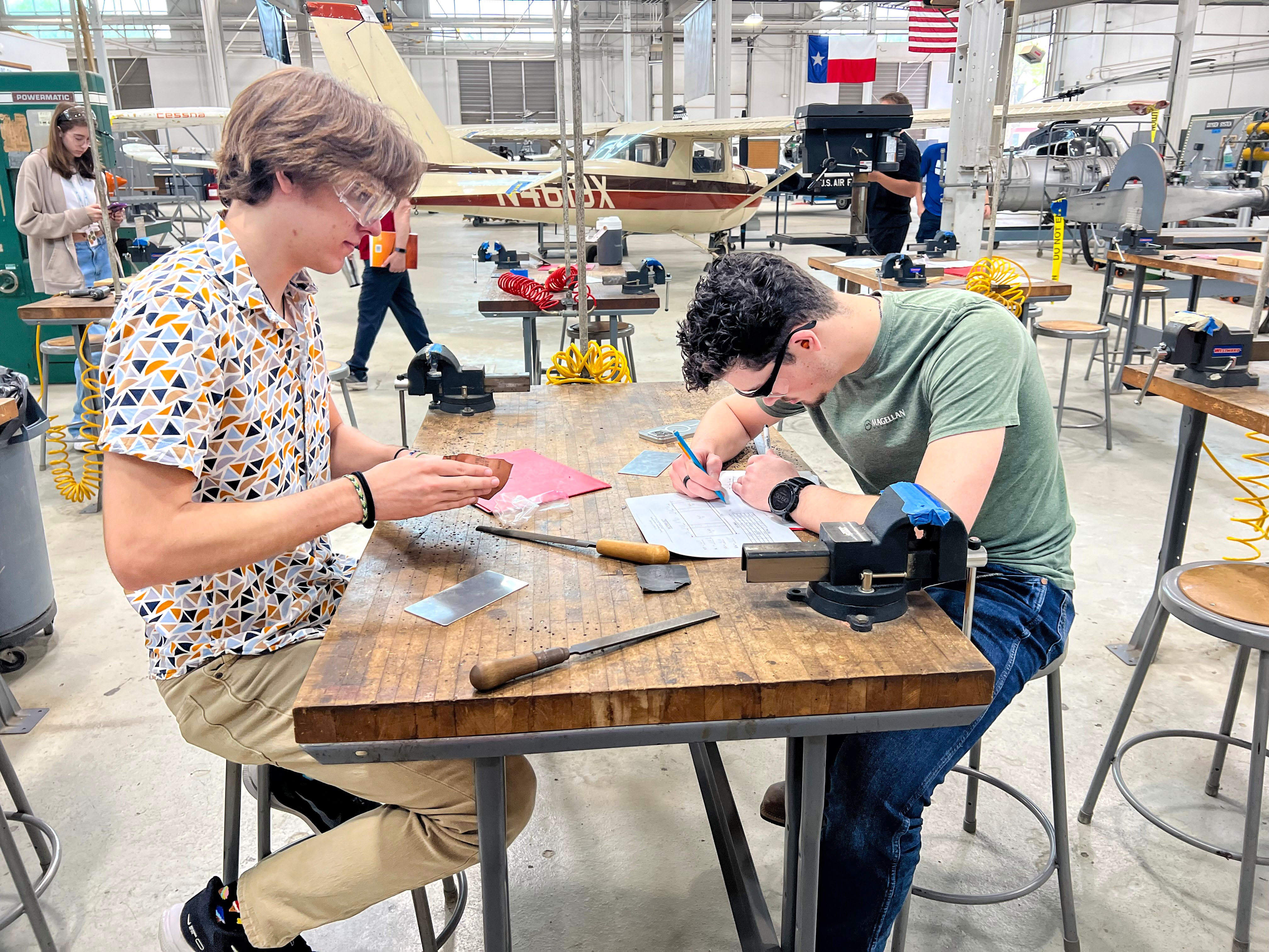 two male students in the lab working with equipment