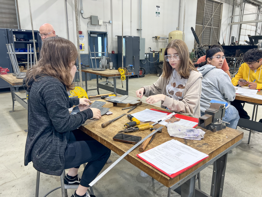 two female students in the lab working with equipment