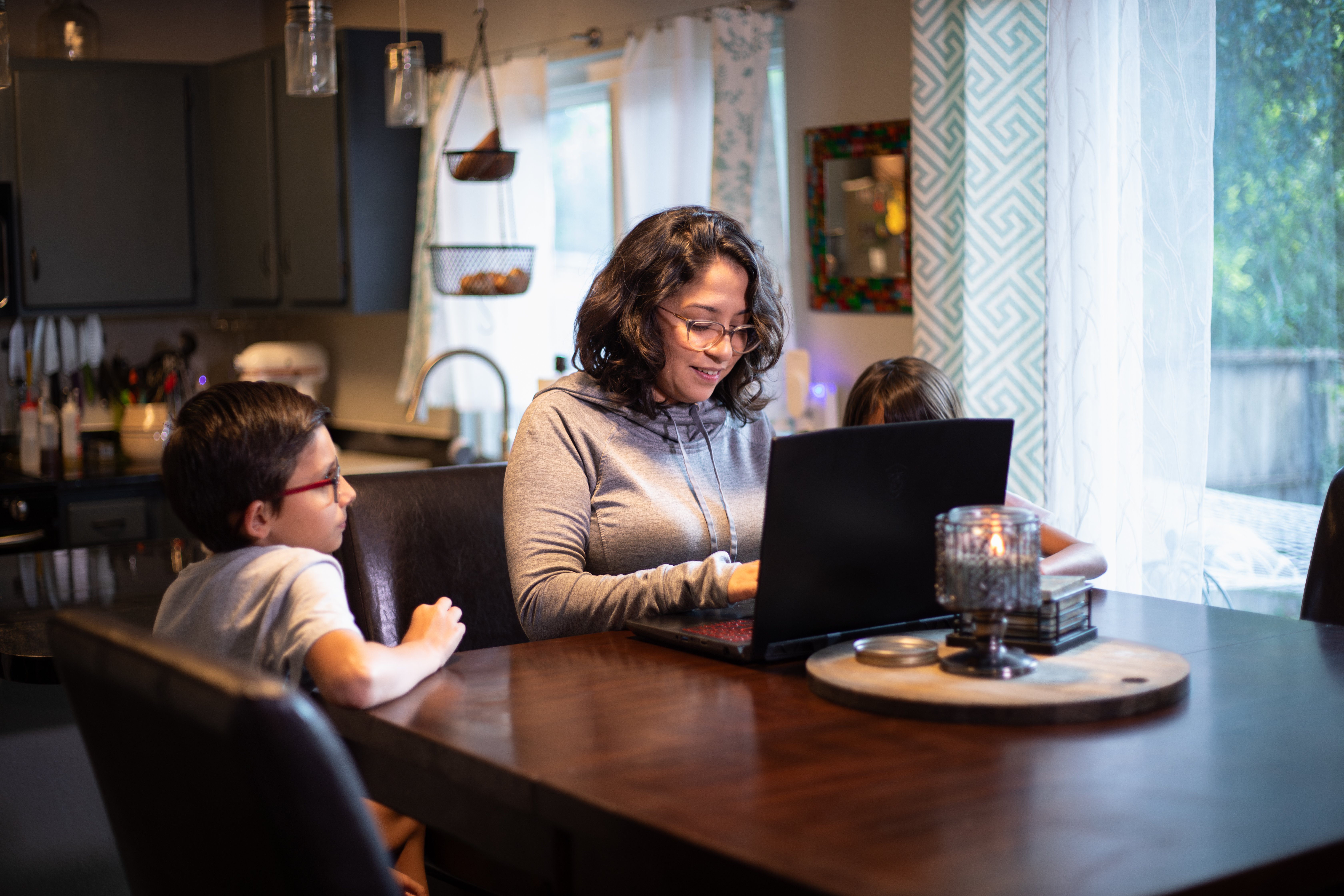 AlamoONLINE student studying with her son