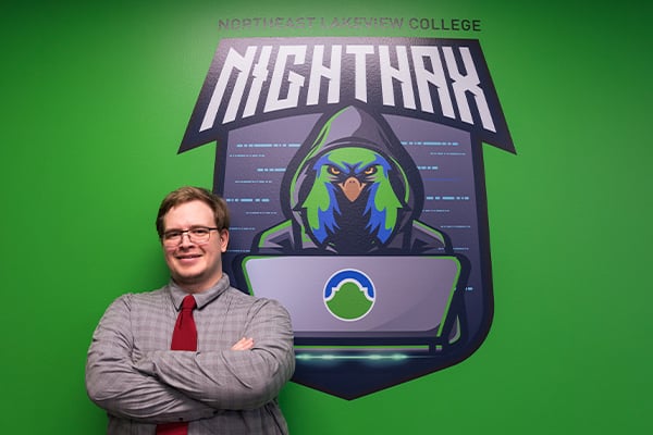 AlamoONLINE student in front of NightHax logo