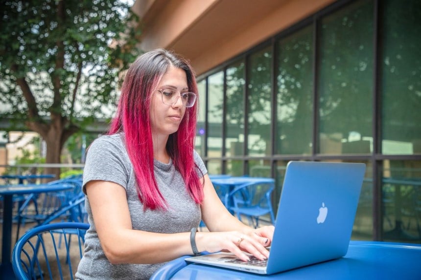 AlamoONLINE female student studying outside of St. Philips College
