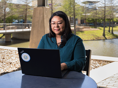 Mia studying on her laptop at her college