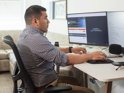 Candido studying on a desktop computer