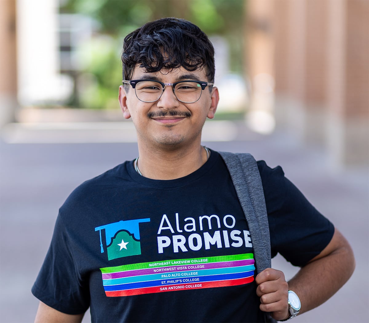 promise student wearing backpack smiling at camera