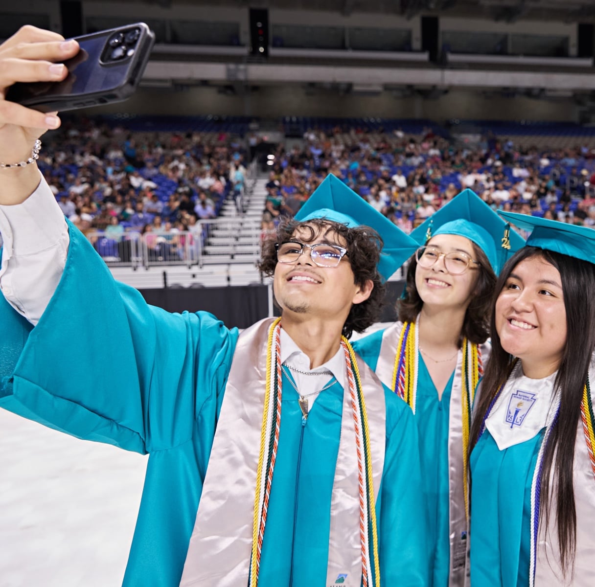 PAC Graduates taking a selfie at graduation