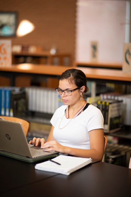 Student studying on laptop in the library