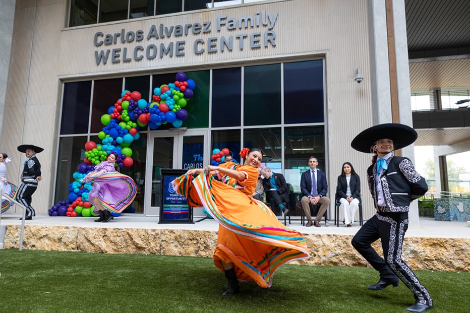 People dancing and twirling in front of building