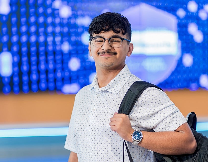 Male student with backpack on shoulder