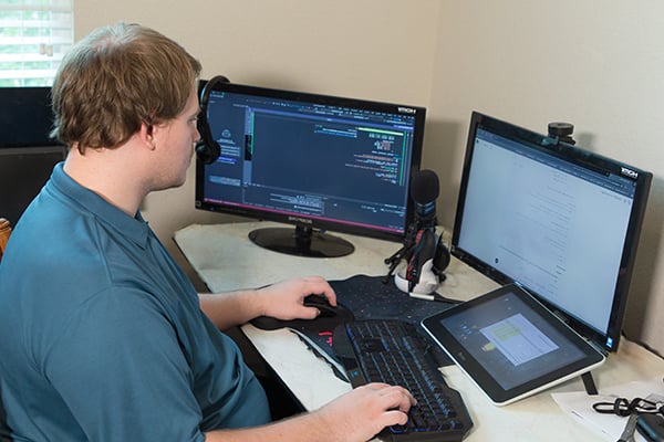 Alexandar and online student at Alamo Colleges at his computer desk at home