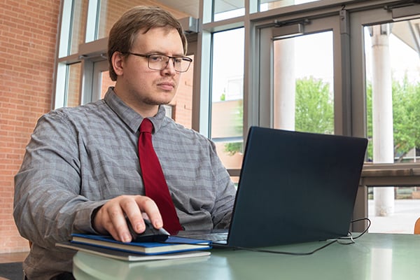 Alexander focused on his laptop