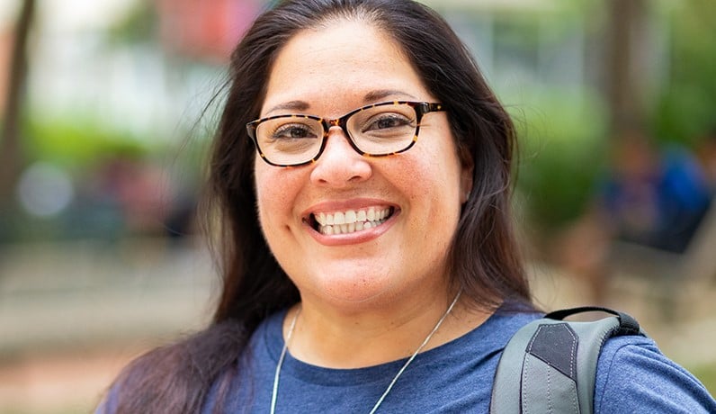 Woman Smiling Outside of Building
