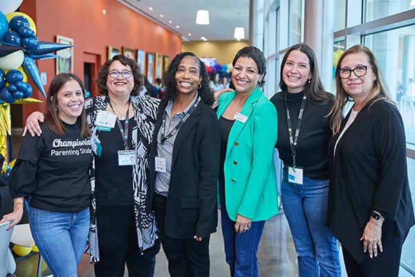 Attendees smiling at the Inaugural State Convening to Support Parenting Students