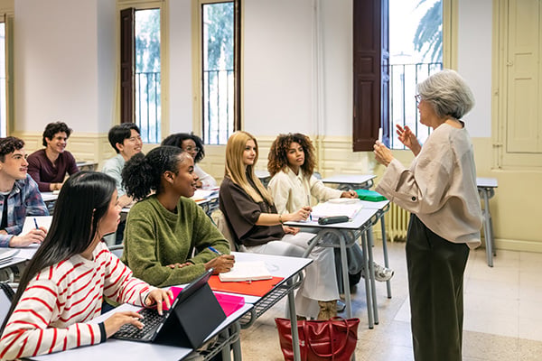 a woman instructing a group of students in a classroom