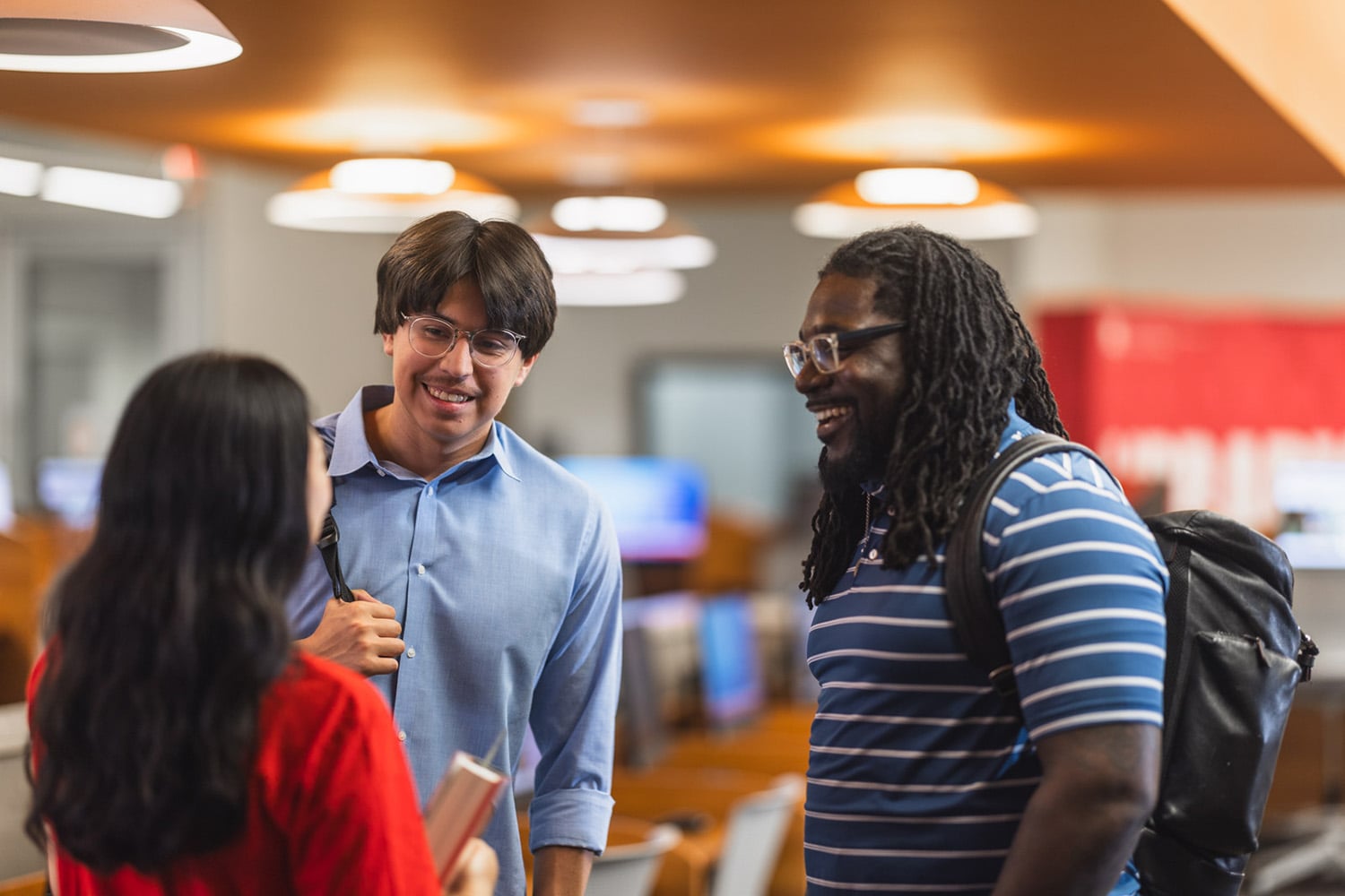 Three Students Talking in Library