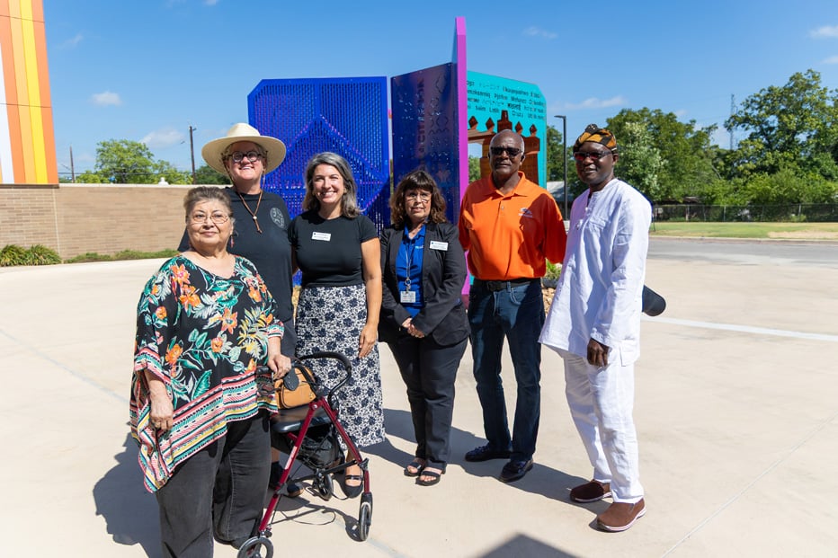 community members in front of artwork unveiling
