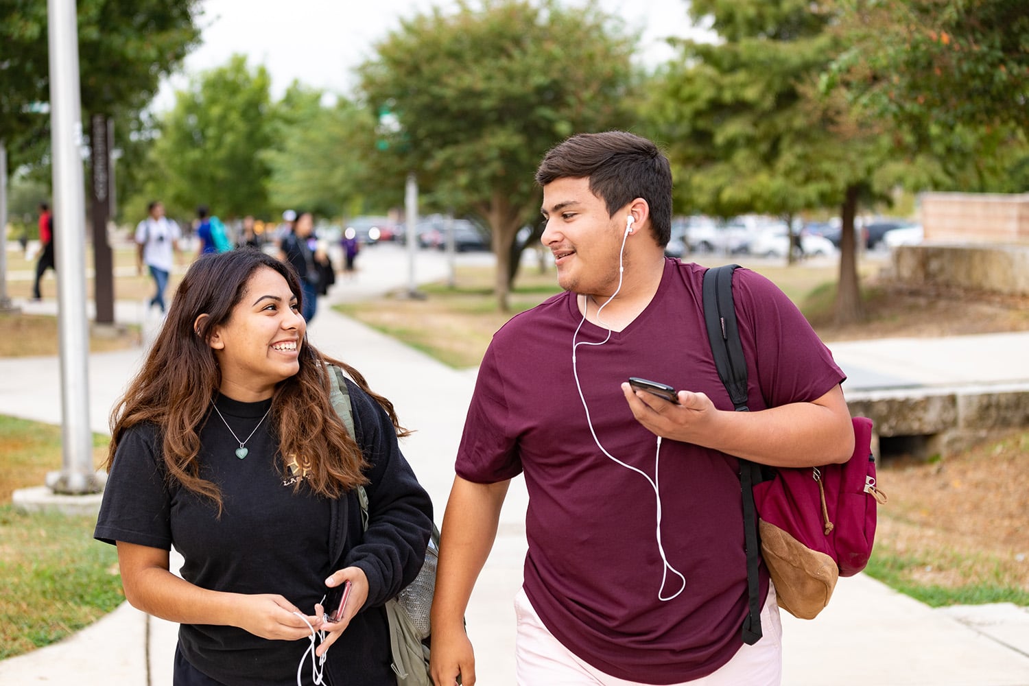 male and female students walking on PAC campus outside
