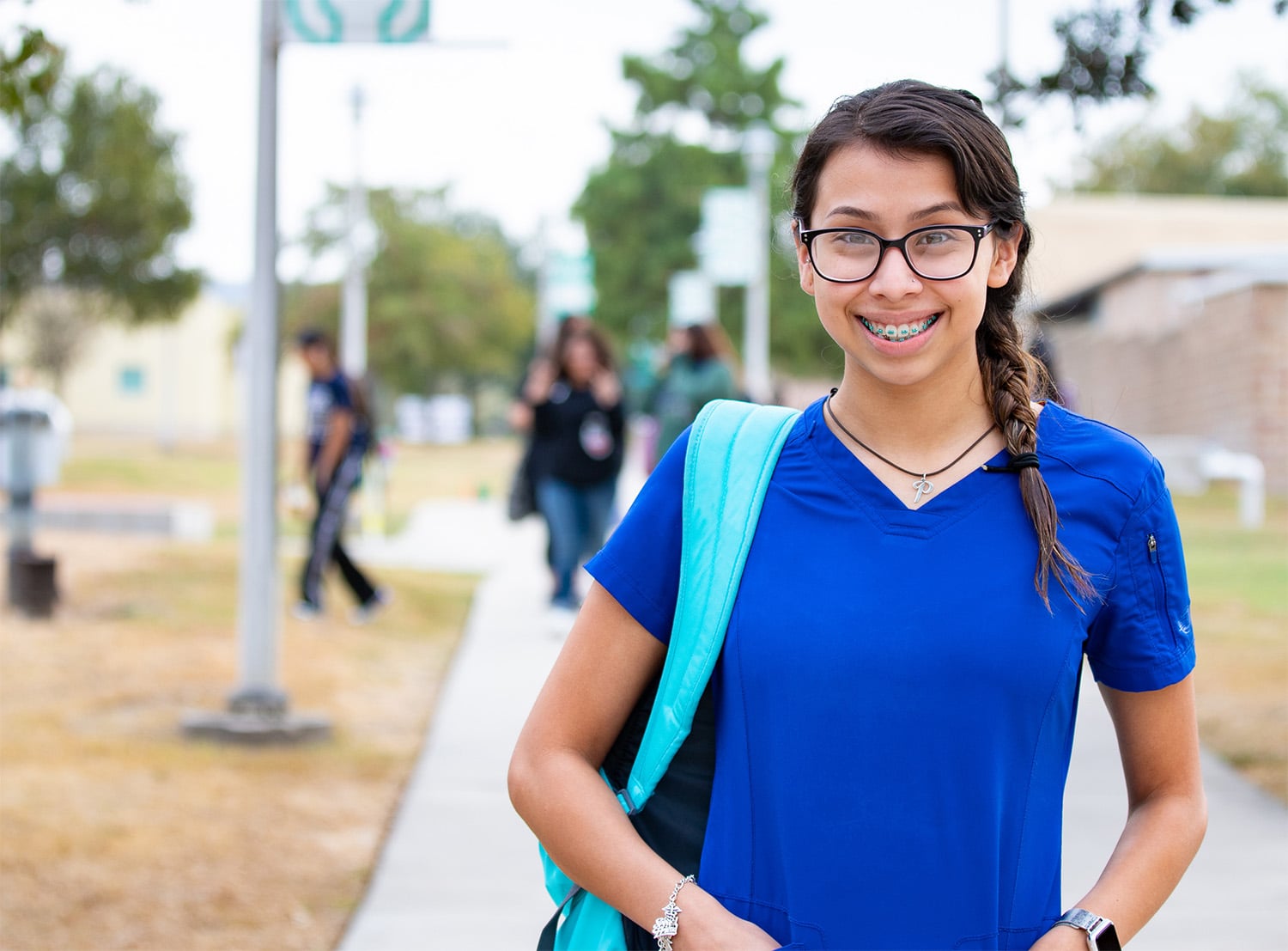 female nursing student standing outside in walkway