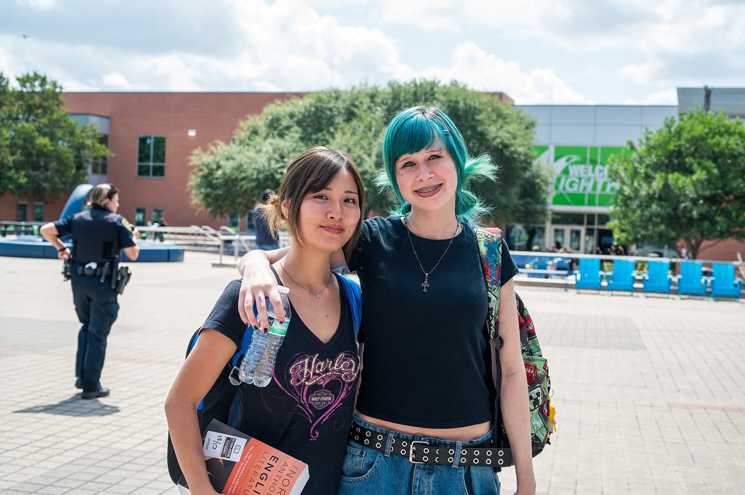 two female students smiling outside campus