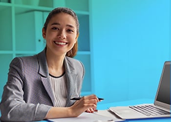 student smiling with laptop