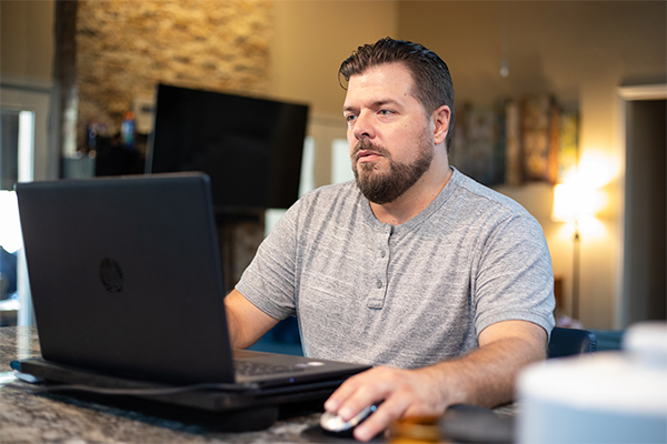 Johnathan an Alamo Colleges online student studying at home