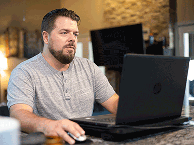 Roger sitting at his computer desk.png