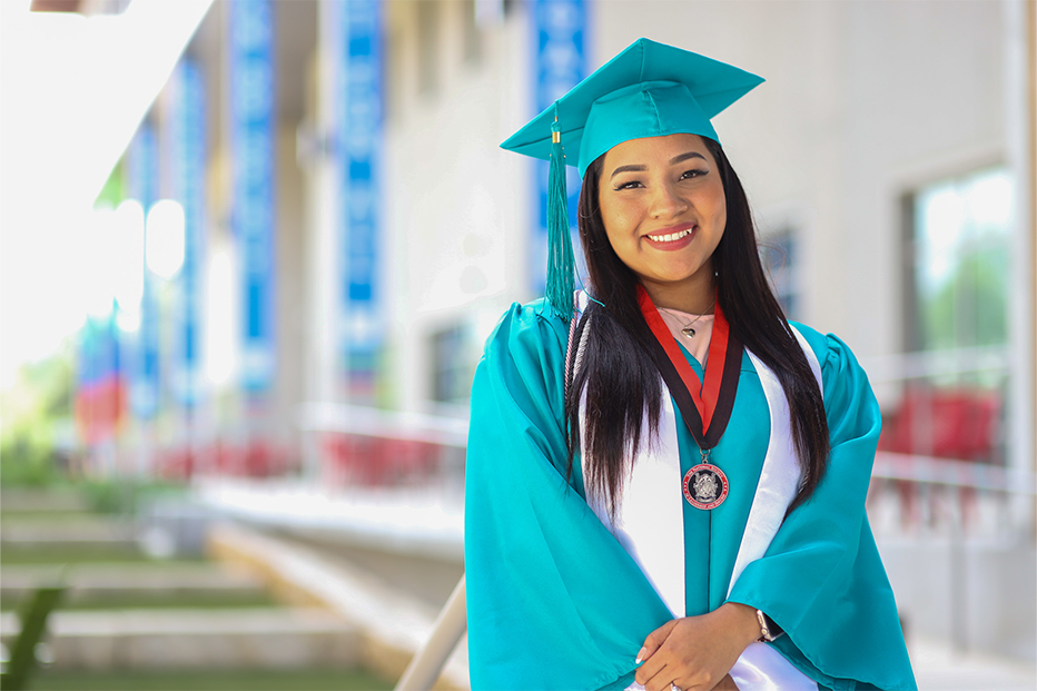 Rebeca Hernandez wearing a Palo Alto College teal graduation cap and gown