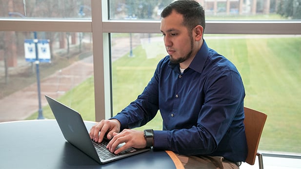 Male Student on his Laptop